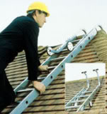 Repairman on the roofing ladder