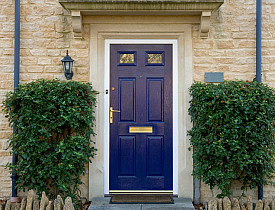 Photo of a blue door flanked by trees via istockphoto.com.