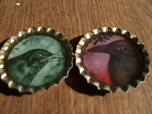 Photo of bottle cap magnets with painted ravens by JenHuff1/Flickr.